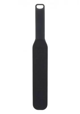 Hidden Desire Paddel, gjord av högkvalitativt silikon, visar upp en strukturerad yta och ett ergonomiskt handtag mot en vit bakgrund.